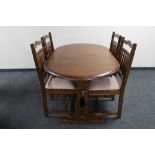 A contemporary oak oval extending table and four chairs
