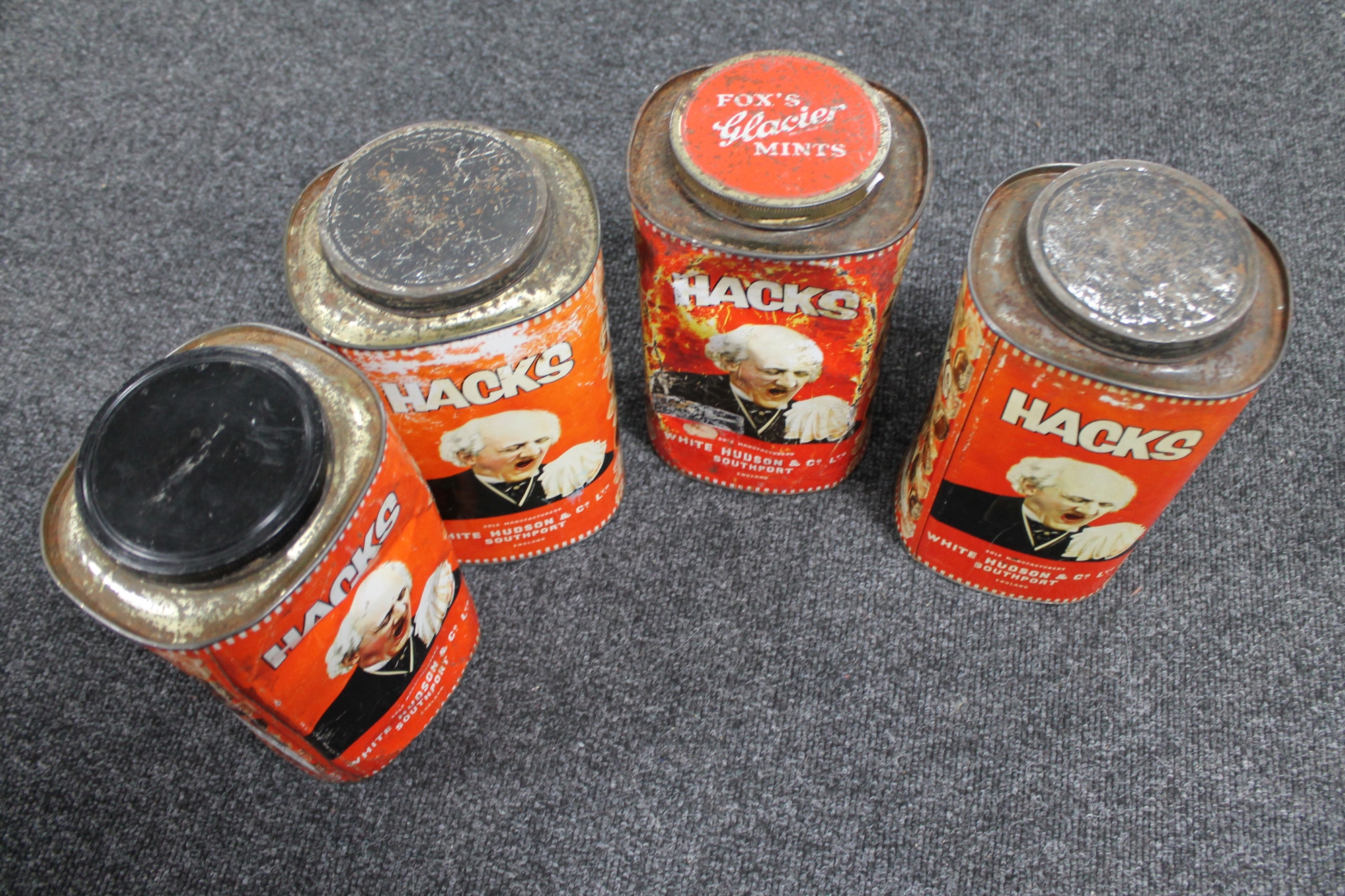 Four vintage metal Hacks tins