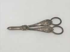 An ornate pair of Victorian silver candle snuffers,