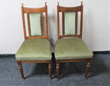 A pair of Edwardian oak dining chairs