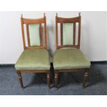 A pair of Edwardian oak dining chairs