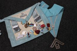 A Freemason's bag and sash together with ten assorted enamelled badges