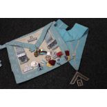 A Freemason's bag and sash together with ten assorted enamelled badges