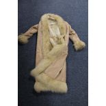 A lady's full length sheep skin coat with faux fur lining