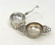 A silver strainer on stand and one other example (2)