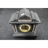 An antique black slate and marble mantle clock with brass and enamel dial