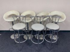 A set of four metal based gas lift bar stools upholstered in a cream faux leather fabric,