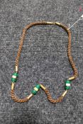 An Art Deco braided hair necklace with gilt metal mounts and studded green glass beads