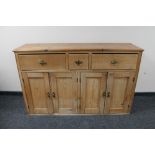 An Edwardian pine four door sideboard fitted with three drawers