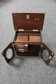 An Edwardian oak smokers cabinet