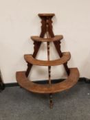 An Edwardian oak demi-lune plant stand,