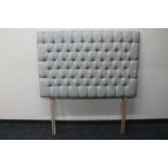 A 4'6 padded headboard in grey buttoned fabric