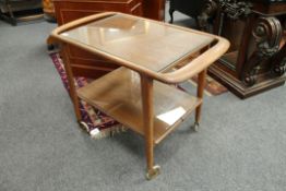A mid century teak trolley manufactured by J.L.M.