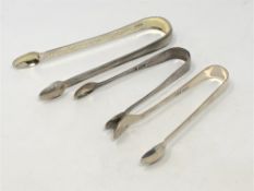 A pair of Georgian silver sugar tongs and two other silver pairs (3) CONDITION REPORT: