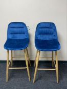 A pair of contemporary breakfast bar chairs on metal legs upholstered in blue fabric