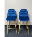 A pair of contemporary breakfast bar chairs on metal legs upholstered in blue fabric