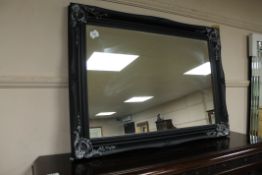 A black framed mirror,