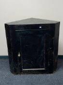 An antique painted pine corner cabinet