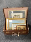 A vintage luggage case containing pictures and prints including a Diana Farrier picture of a wolf,