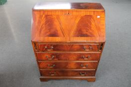 A Regency style mahogany bureau fitted with four drawers