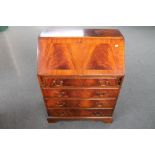 A Regency style mahogany bureau fitted with four drawers