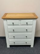 A contemporary oak topped five drawer chest