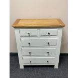 A contemporary oak topped five drawer chest