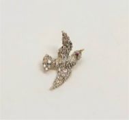 A superb quality antique diamond set swallow brooch with ruby eye,