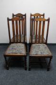 A set of four oak rail backed dining chairs