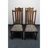 A set of four oak rail backed dining chairs