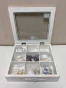 A display case jewellery box containing silver jewellery,