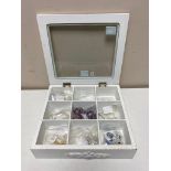 A display case jewellery box containing silver jewellery,