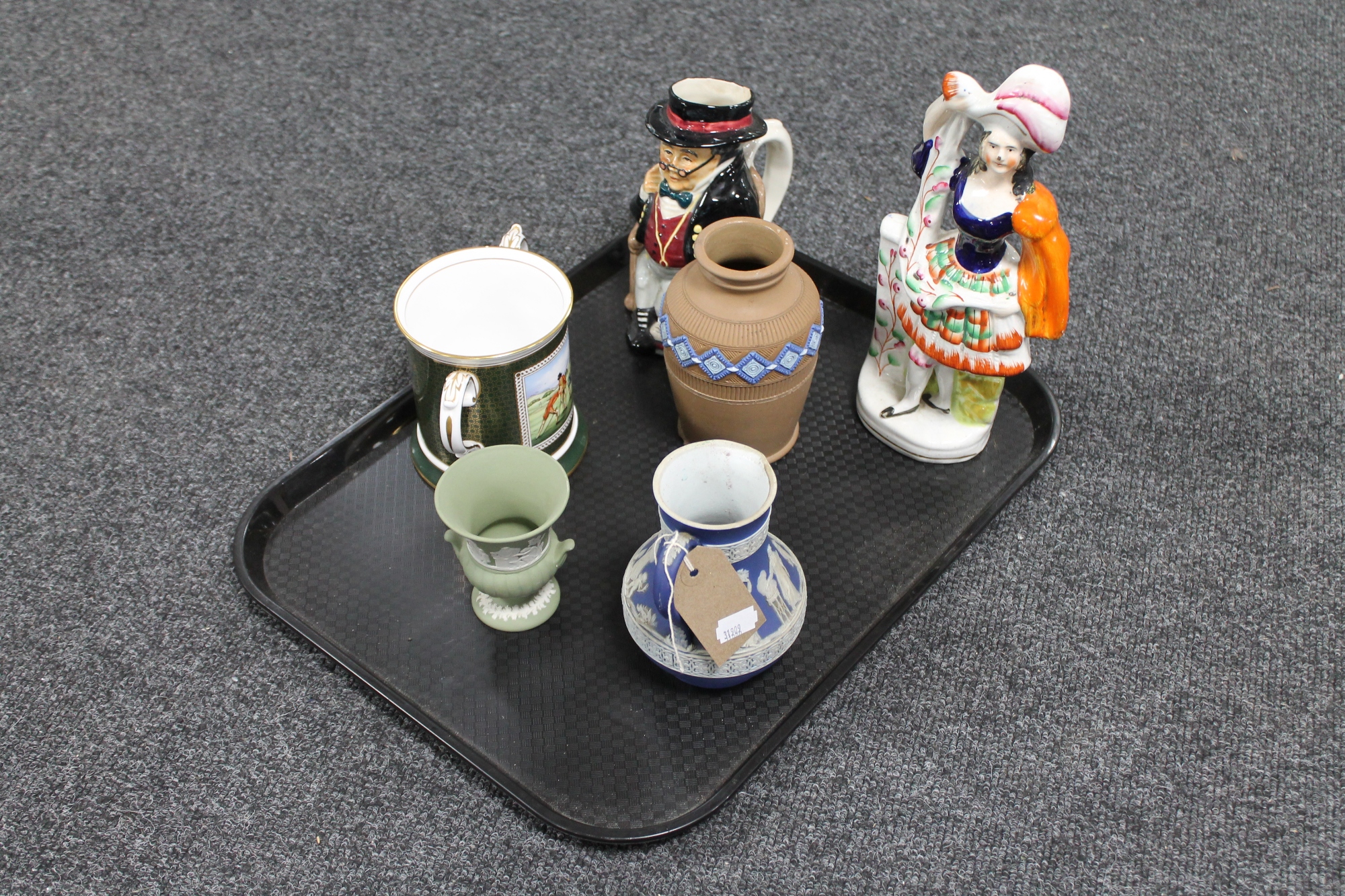 A tray of flat backed Staffordshire figure highland dancer, Mr Pickwick Toby jug,