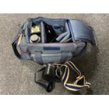 A camera bag containing Olympus OM10 camera,