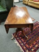 A 19th century flap sided pedestal table,