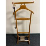 A mid century valet stand together with a tie master roller and shoe horn with jockey head handle