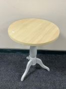 A contemporary circular wine table on painted base