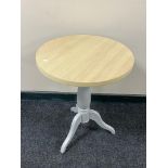 A contemporary circular wine table on painted base