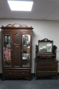 An Edwardian double mirrored wardrobe together with a dressing chest with triple mirror