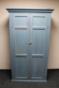 An antique painted pine double door cabinet