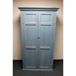 An antique painted pine double door cabinet