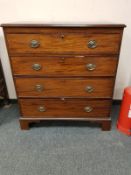 A George III mahogany four drawer chest on bracket feet,