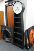 A set of contemporary open bookshelves fitted with battery powered clock