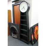 A set of contemporary open bookshelves fitted with battery powered clock