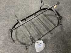 A black metal kitchen hanging pan rack with chains