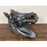 A metal wall mounted horses head