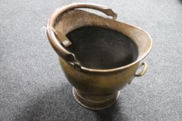 A hammered brass antique coal bucket