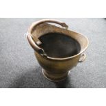 A hammered brass antique coal bucket