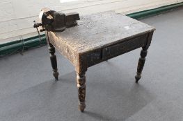 An antique pine kitchen table fitted with a drawer with heavy duty bench vice (a/f)