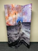 A three way folding room divider depicting Neil Armstrong on the moon